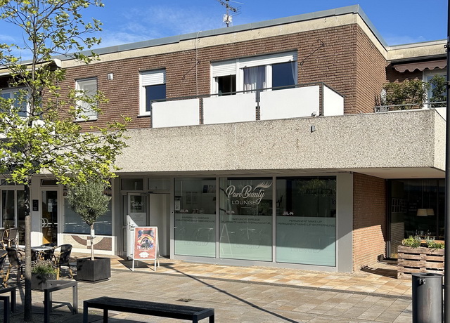 Blick auf ein Wohn- und Geschäftshaus im Zentrum von Hövelhof. Im Erdgeschoss befindet sich ein Laden, darüber eine Wohnung.