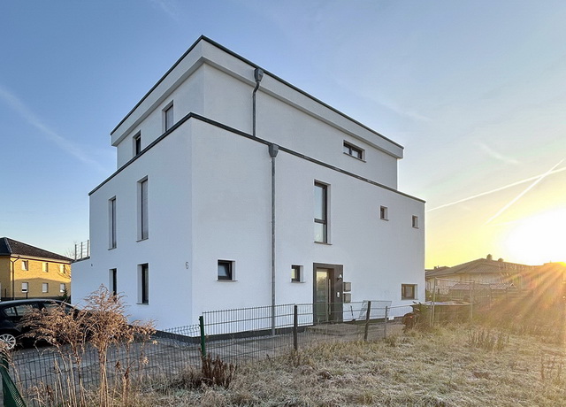 Blick auf das Zweifamilienhaus in Delbrück mit weißer Fassade
